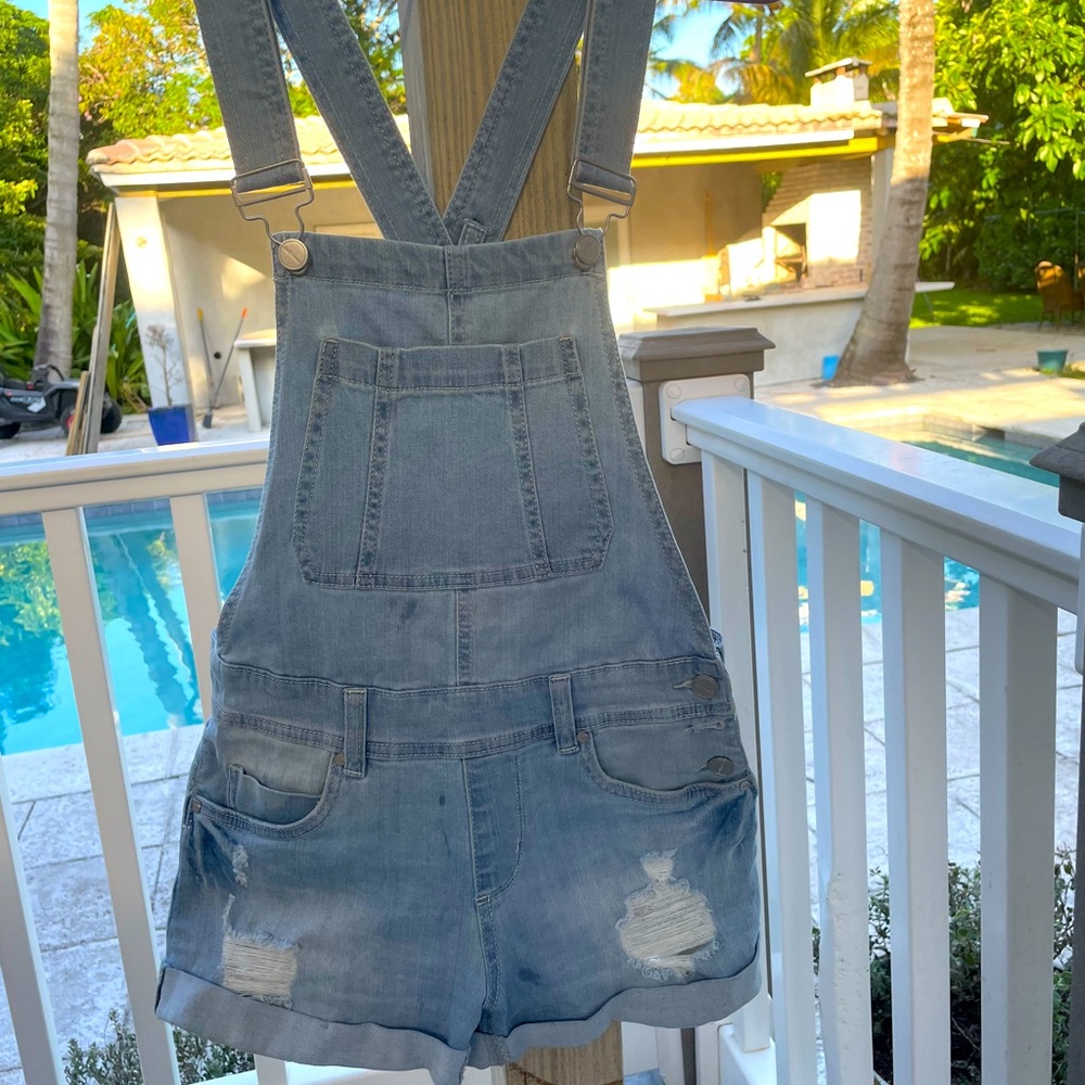Distressed roll hem shorts overalls light wash cross strap silvertone hardware